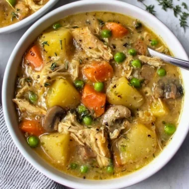 Slow cooker chicken stew with vegetables and herbs in a cozy bowl