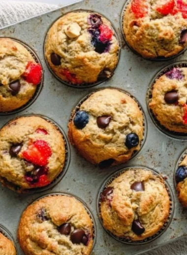 Freshly baked yogurt muffins on a rustic wooden table.