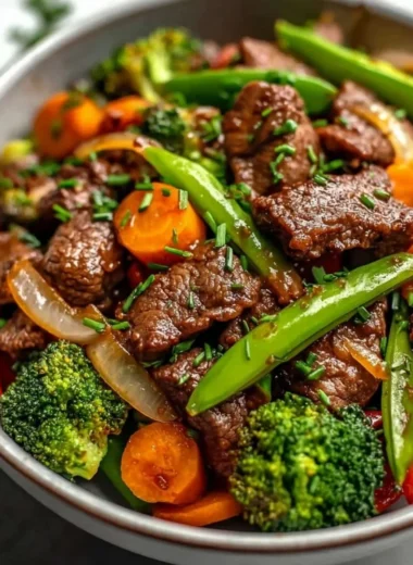 Beef stir fry with colorful vegetables in a skillet