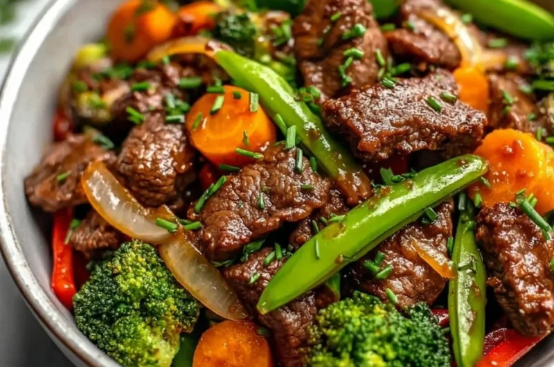 Beef stir fry with colorful vegetables in a skillet