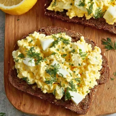 Delicious cottage cheese egg salad sandwich on a plate with fresh greens