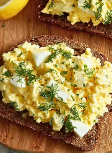 Delicious cottage cheese egg salad sandwich on a plate with fresh greens