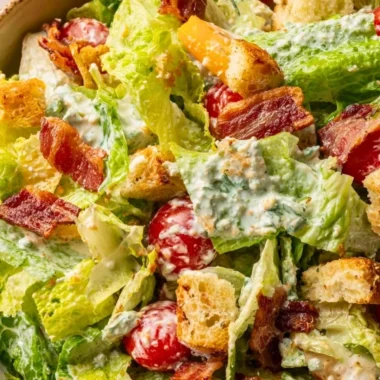 Delicious BLT Salad with bacon, lettuce, and tomatoes on a white plate