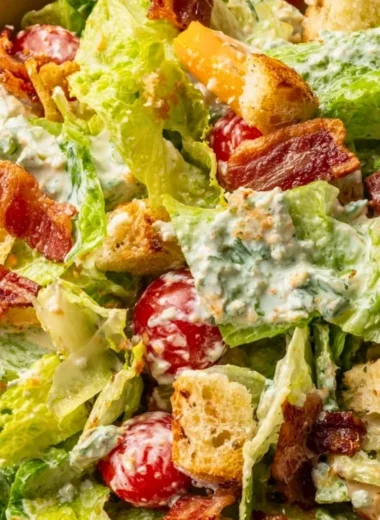 Delicious BLT Salad with bacon, lettuce, and tomatoes on a white plate
