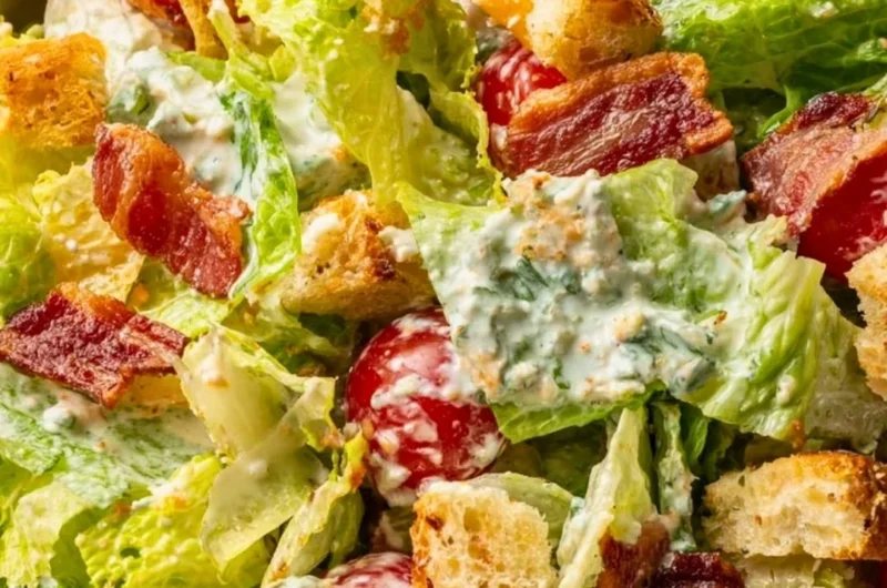 Delicious BLT Salad with bacon, lettuce, and tomatoes on a white plate