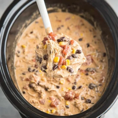 Bowl of delicious Crockpot White Chicken Chili garnished with cilantro and lime.