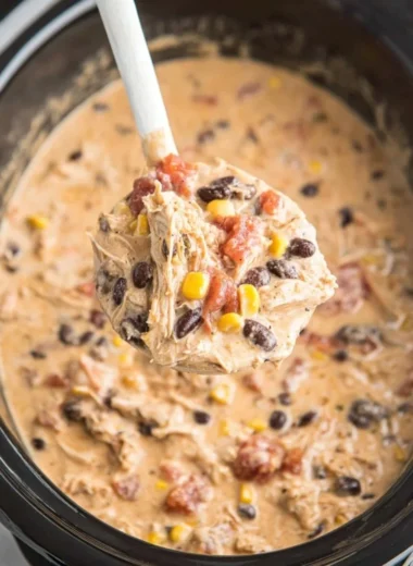 Bowl of delicious Crockpot White Chicken Chili garnished with cilantro and lime.