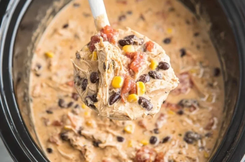 Bowl of delicious Crockpot White Chicken Chili garnished with cilantro and lime.