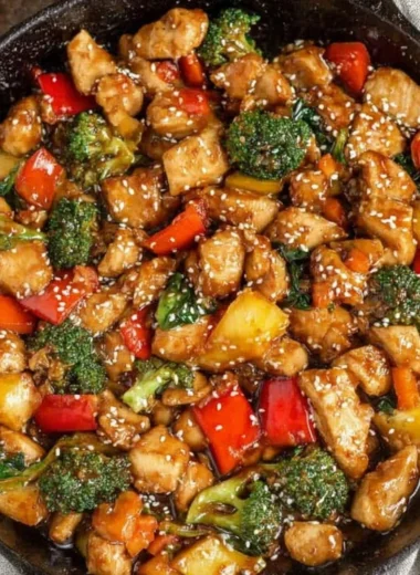 A colorful easy chicken stir fry with vegetables on a plate.