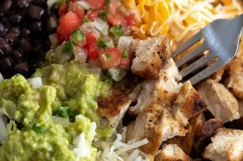 Grilled chicken burrito bowl with rice and beans, fresh ingredients, and vibrant colors.