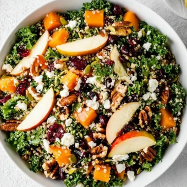 Colorful healthy fall salad with seasonal ingredients like apples, nuts, and greens