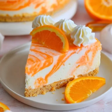 Delicious no-bake orange creamsicle cheesecake with a creamy texture and vibrant color