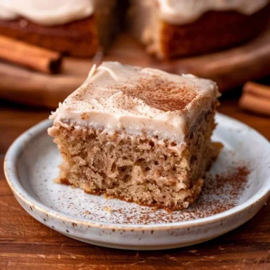 Delicious spiced chai cake topped with a sprinkle of cinnamon and served on a plate