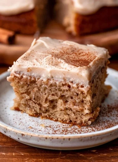 Delicious spiced chai cake topped with a sprinkle of cinnamon and served on a plate