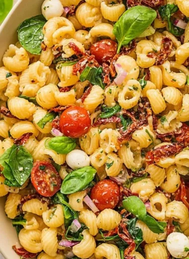 Delicious Sun Dried Tomato Pasta Salad with colorful vegetables and herbs