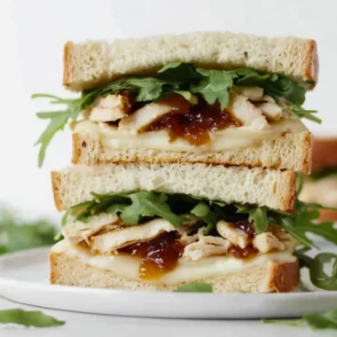 A delicious and colorful sandwich filled with fresh ingredients and served on crusty bread.