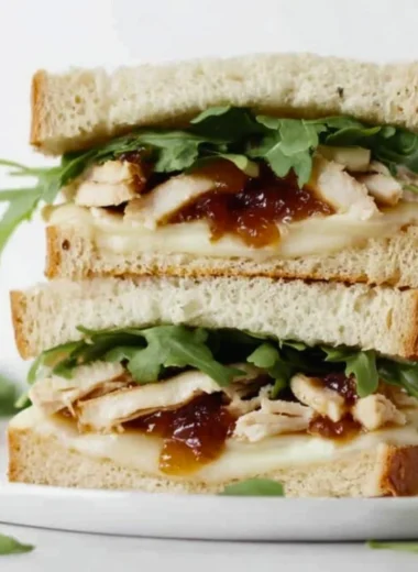 A delicious and colorful sandwich filled with fresh ingredients and served on crusty bread.