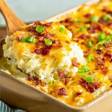 Delicious twice baked potato casserole topped with cheese and green onions.