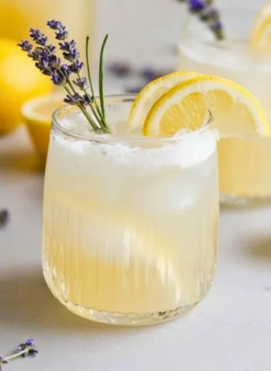 Coconut Lavender Lemonade mocktail served in a glass with lavender sprigs.