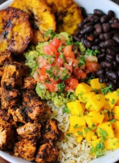 Cuban chicken served in a Black Bean Rice Bowl with vibrant toppings