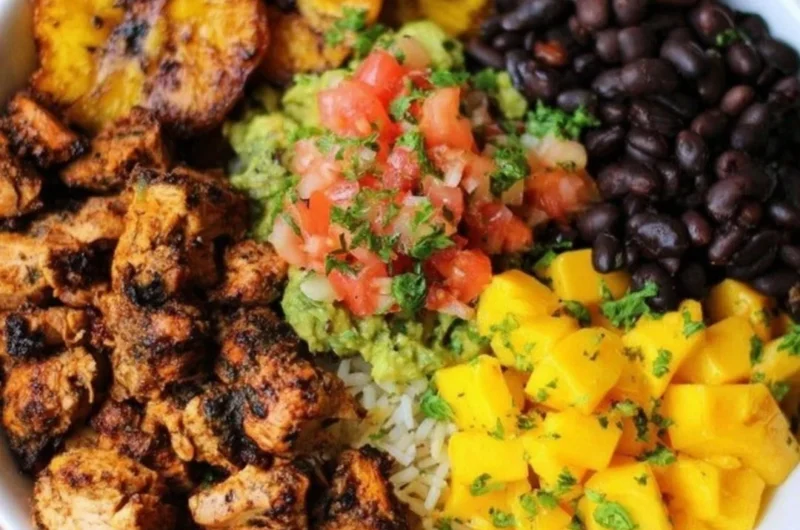 Cuban chicken served in a Black Bean Rice Bowl with vibrant toppings