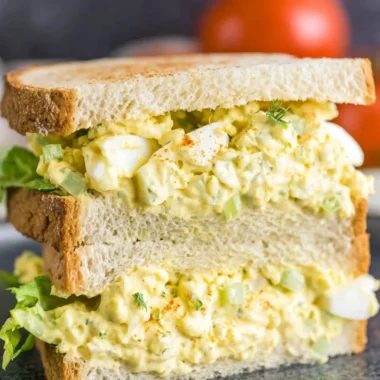 Creamy egg salad served in a bowl with spices and herbs
