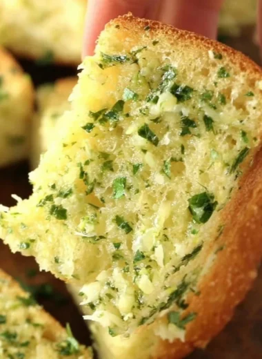 Freshly baked homemade garlic bread with herbs and melted butter