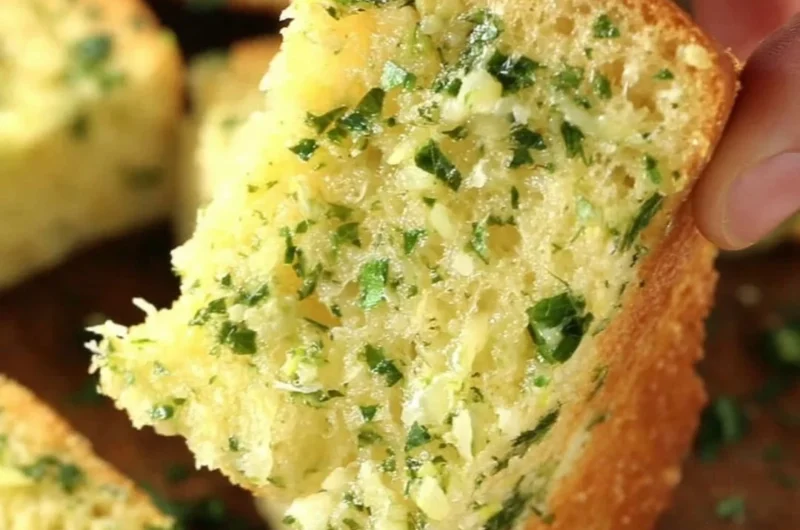 Freshly baked homemade garlic bread with herbs and melted butter