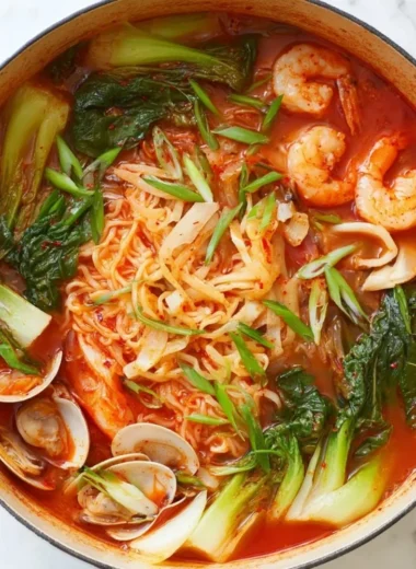 Delicious bowl of Korean seafood noodle soup with fresh ingredients and herbs