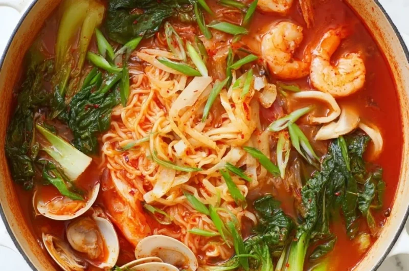 Delicious bowl of Korean seafood noodle soup with fresh ingredients and herbs