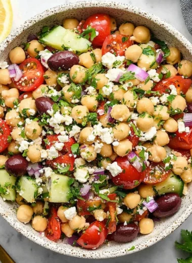 A vibrant Mediterranean Chickpea Salad with chickpeas, tomatoes, cucumber, and olives.