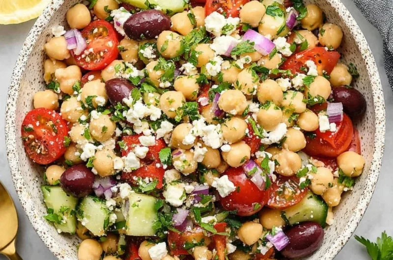A vibrant Mediterranean Chickpea Salad with chickpeas, tomatoes, cucumber, and olives.