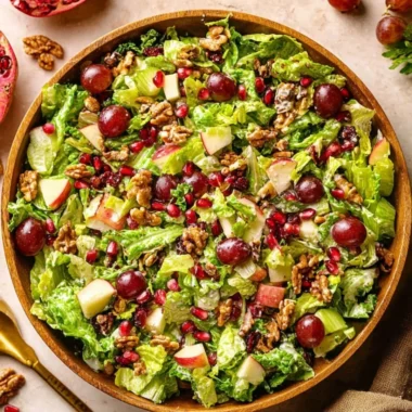 A vibrant bowl of Modern Waldorf Salad with apples, walnuts, and grapes.