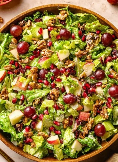 A vibrant bowl of Modern Waldorf Salad with apples, walnuts, and grapes.