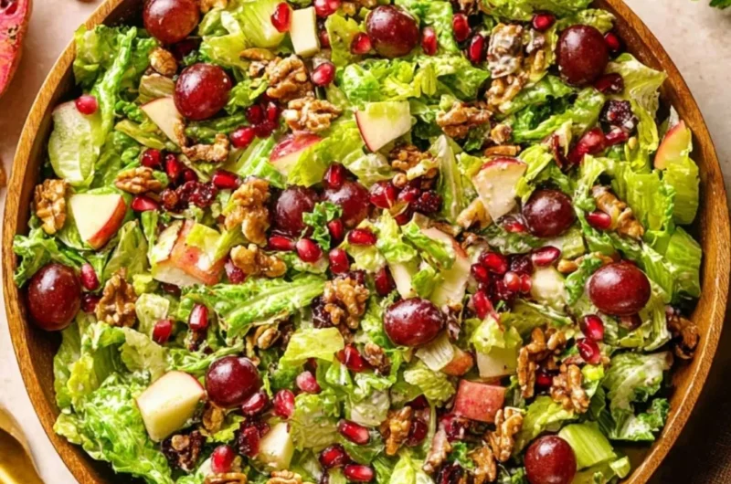 A vibrant bowl of Modern Waldorf Salad with apples, walnuts, and grapes.