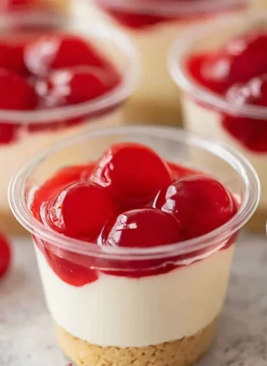 Delicious no-bake cheesecake cups topped with fresh fruit and whipped cream