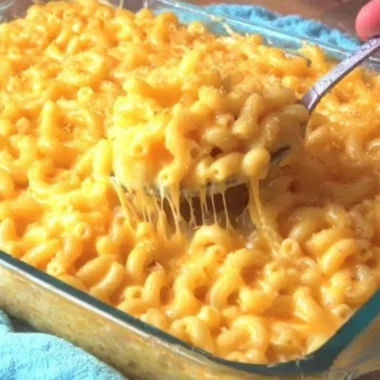 Creamy macaroni and cheese served in a bowl, showcasing rich cheese and pasta.