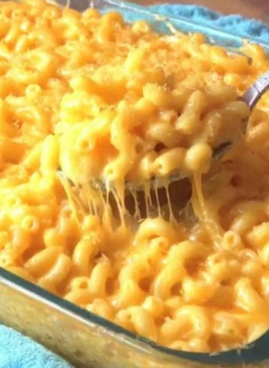 Creamy macaroni and cheese served in a bowl, showcasing rich cheese and pasta.