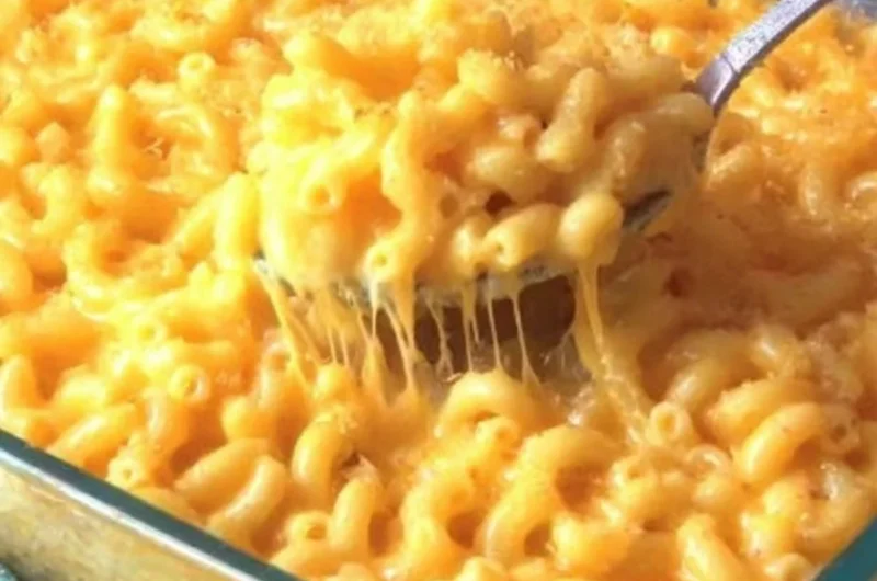 Creamy macaroni and cheese served in a bowl, showcasing rich cheese and pasta.