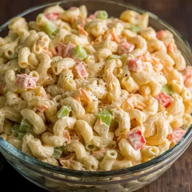 Bowl of small macaroni salad with colorful vegetables and dressing
