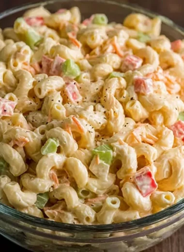 Bowl of small macaroni salad with colorful vegetables and dressing