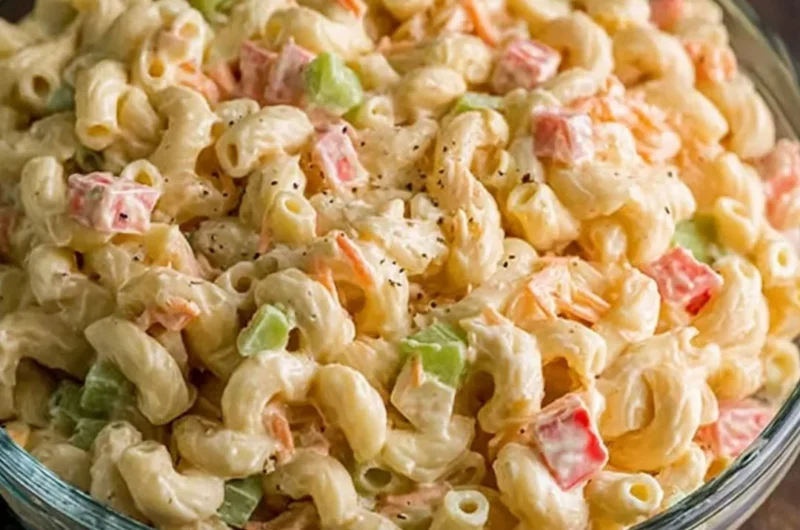 Bowl of small macaroni salad with colorful vegetables and dressing