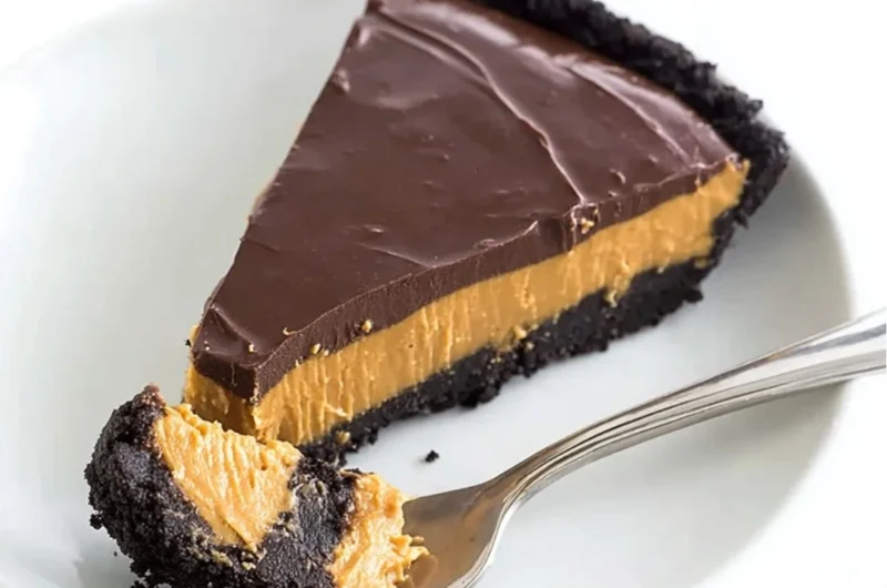 No bake chocolate peanut butter pie topped with chocolate drizzle and peanuts