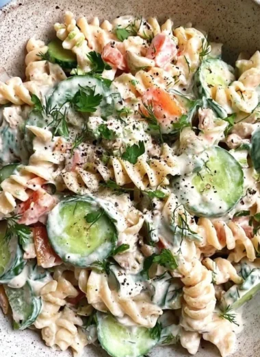 Bowl of Tzatziki Pasta Salad with fresh herbs and vegetables