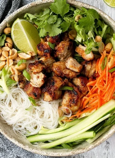 Vietnamese noodle bowl featuring lemongrass chicken and vibrant vegetables