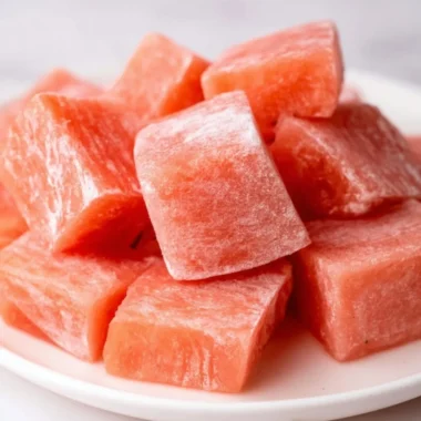 Delicious watermelon mochi with vibrant pink filling and white rice exterior.