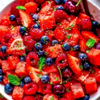 Colorful bowl of Watermelon Salad with feta cheese and mint leaves